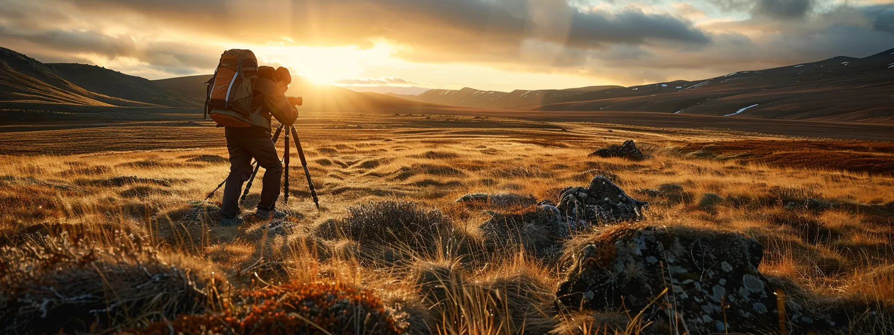 a photographer setting up a sturdy tripod in a rugged landscape, preparing for a wildlife photography shoot.