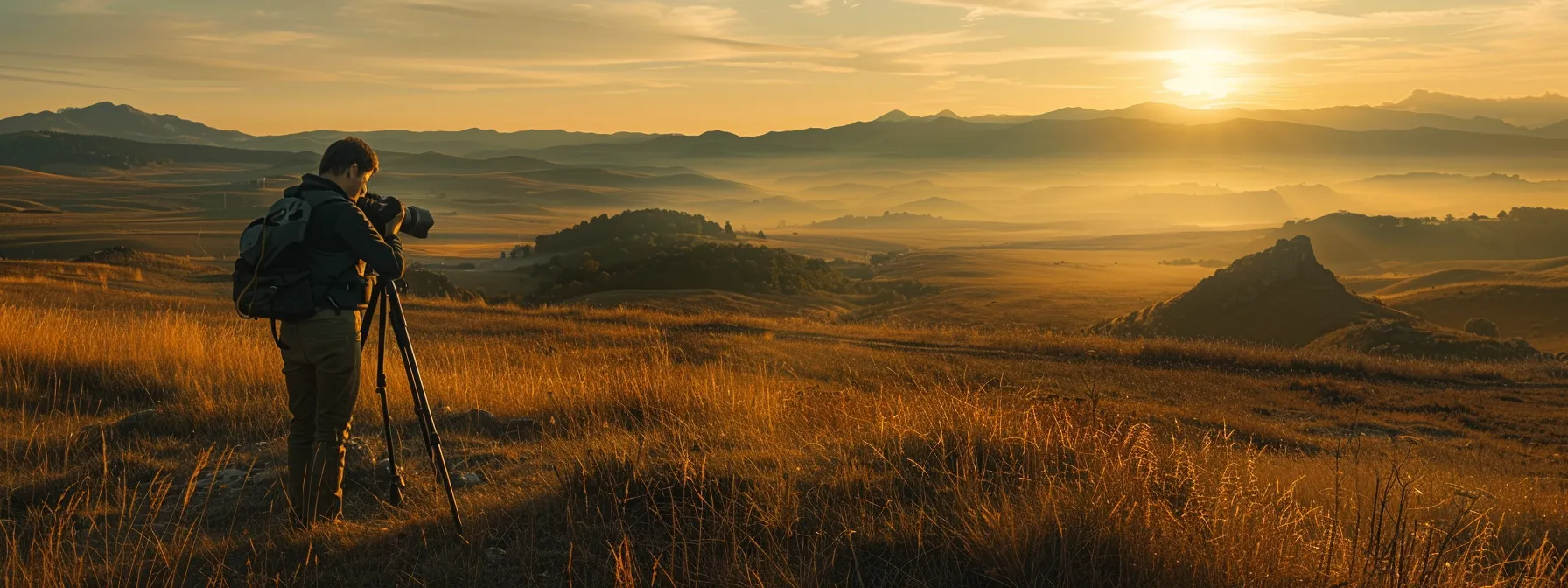a photographer adjusts a ball head tripod mount while capturing a stunning landscape.
