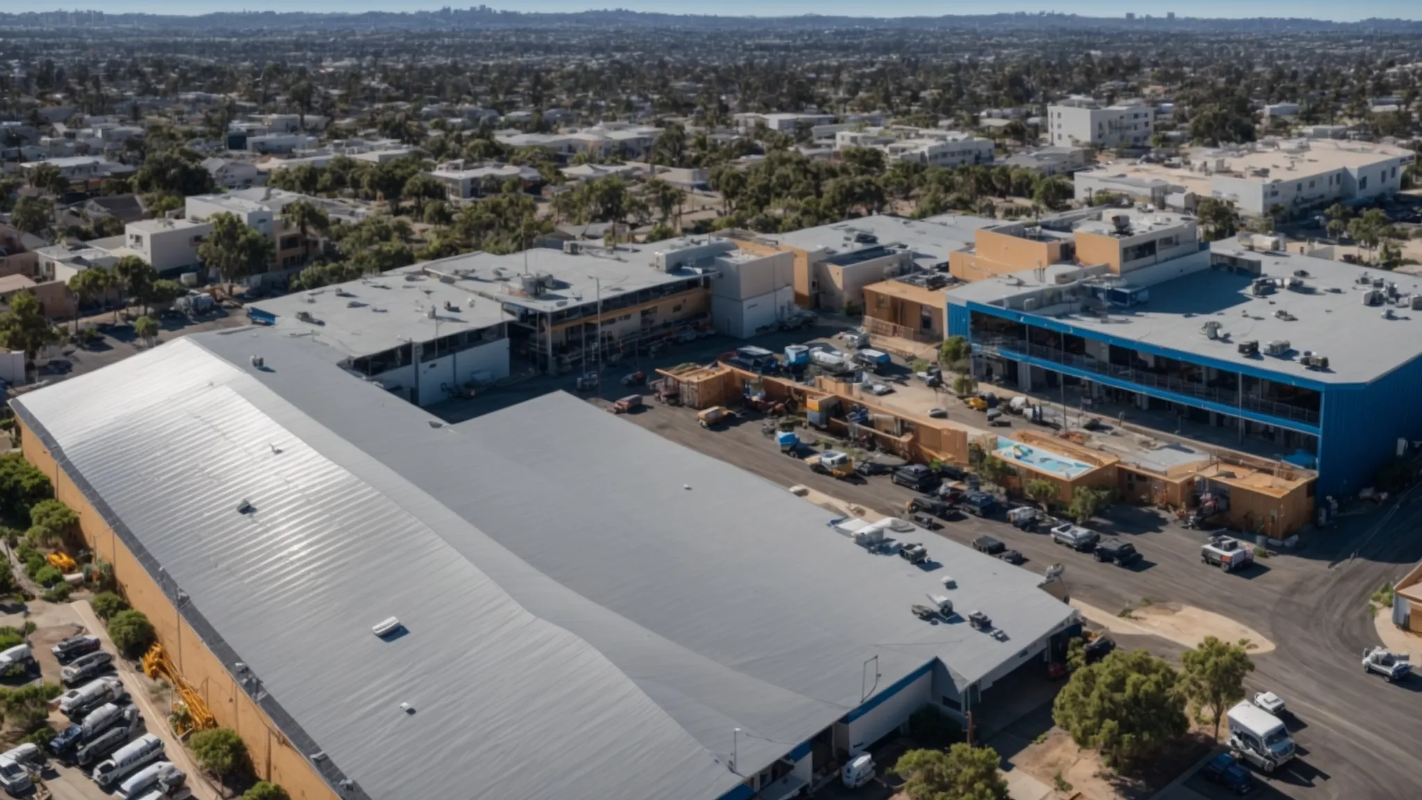 a panoramic view of a skilled roofing crew expertly installing asphalt shingles on a commercial building in san diego, showcasing a clean and organized worksite under bright blue skies and vibrant sunlight.